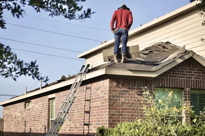 Professional roofer working on a residential roof in Snake Hill